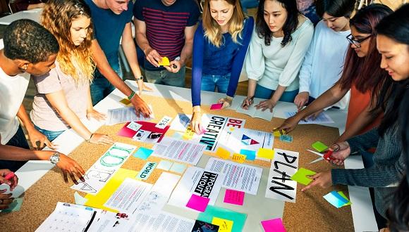 Students in a co-creation exercise involving a planning board