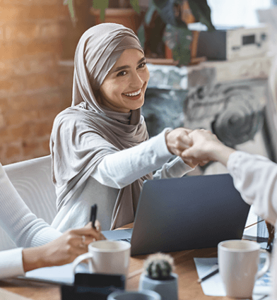 Woman shaking hands across a table